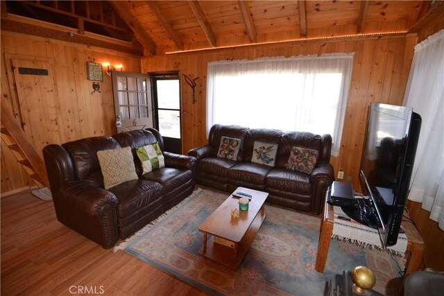 living room featuring hardwood / wood-style floors, lofted ceiling with beams, wooden walls, and wood ceiling