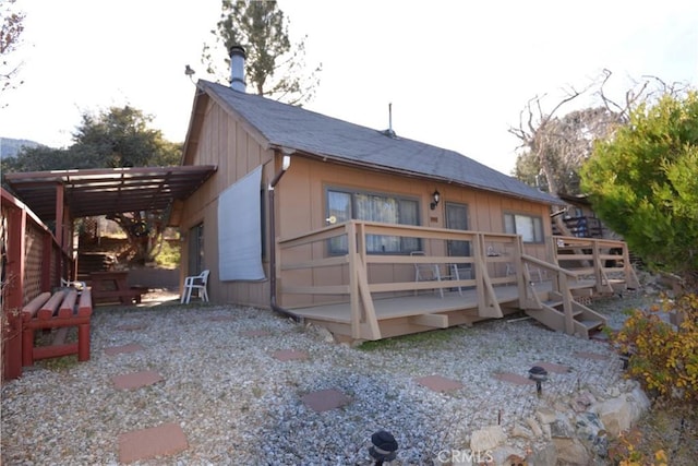 back of property with a wooden deck