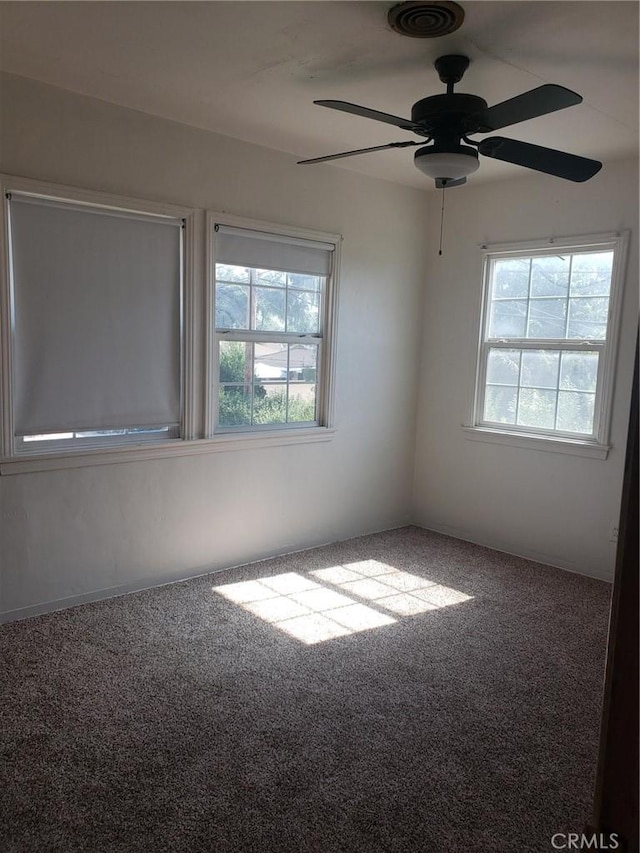 empty room with ceiling fan and carpet flooring