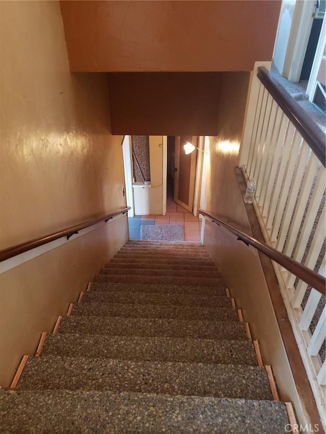 staircase featuring tile patterned floors