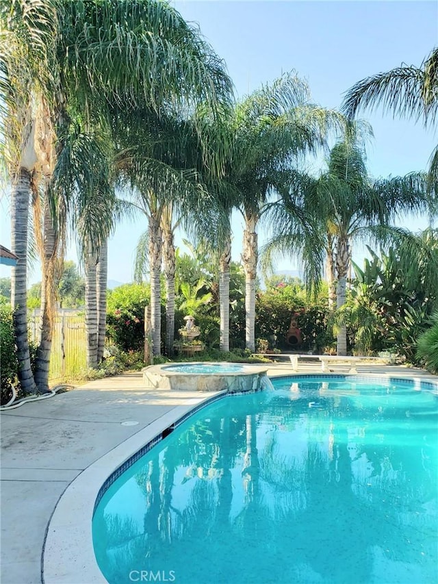 view of pool with an in ground hot tub and a patio