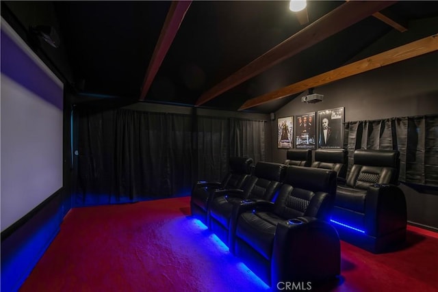 cinema room featuring lofted ceiling with beams and carpet flooring