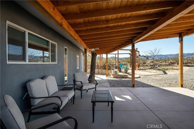 view of patio / terrace featuring an outdoor living space and a mountain view