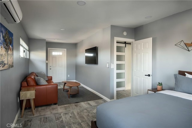 bedroom featuring a closet, a wall unit AC, and a barn door