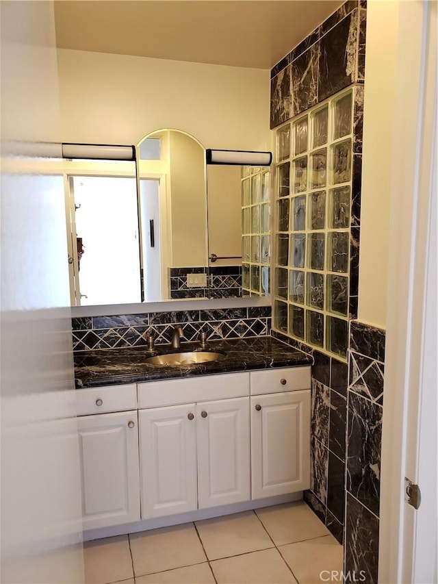 bathroom featuring tile patterned floors, vanity, and tile walls