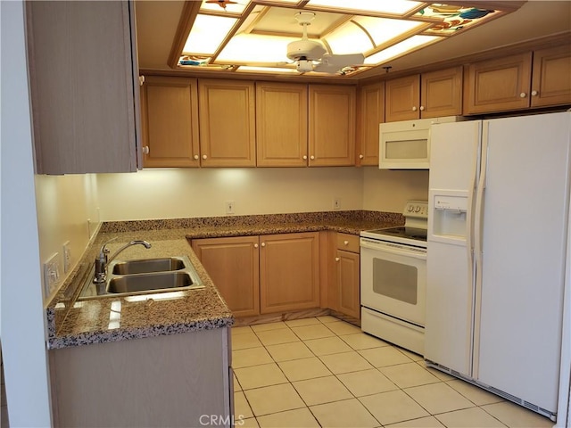 kitchen featuring light tile patterned floors, white appliances, and sink