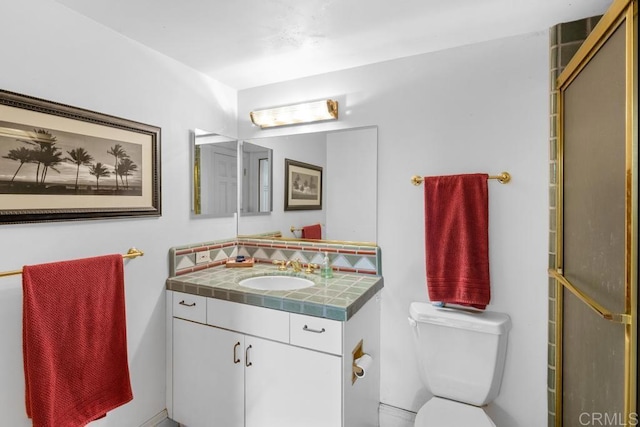 bathroom featuring toilet, tasteful backsplash, and vanity