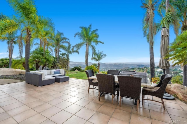 view of patio / terrace featuring outdoor dining area, outdoor lounge area, and a mountain view