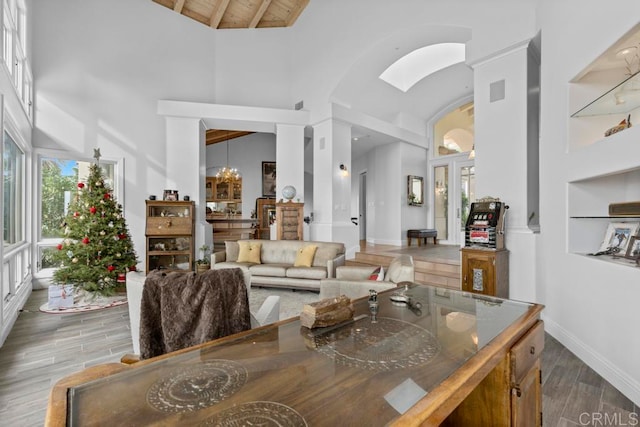 interior space with beamed ceiling, an inviting chandelier, dark wood-type flooring, and high vaulted ceiling