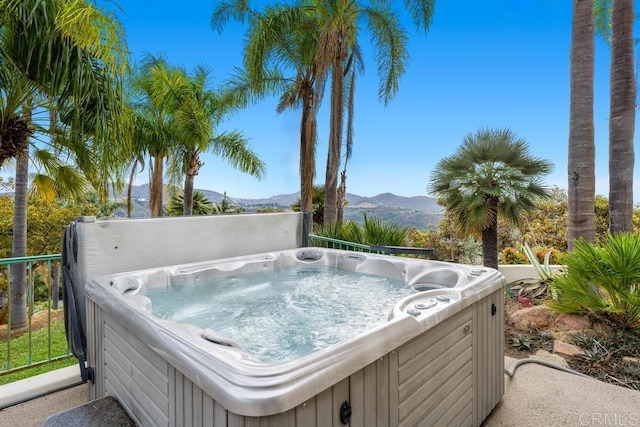 exterior space featuring a hot tub and a mountain view