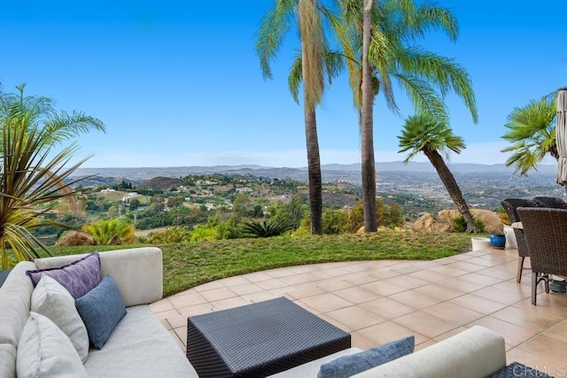 view of patio / terrace featuring an outdoor living space and a mountain view