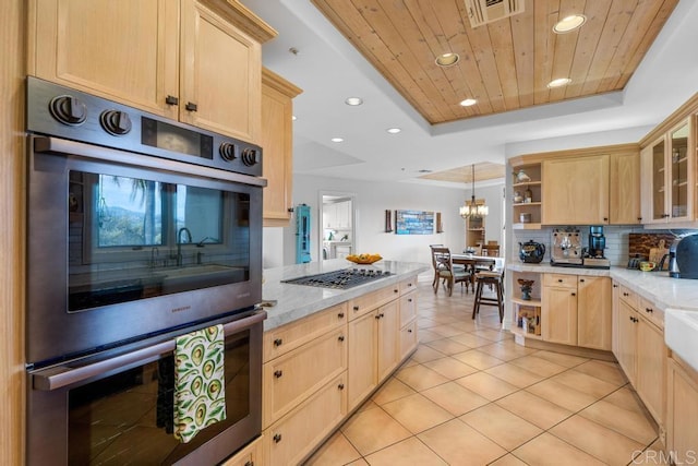 kitchen with light brown cabinetry, open shelves, appliances with stainless steel finishes, light tile patterned flooring, and decorative backsplash