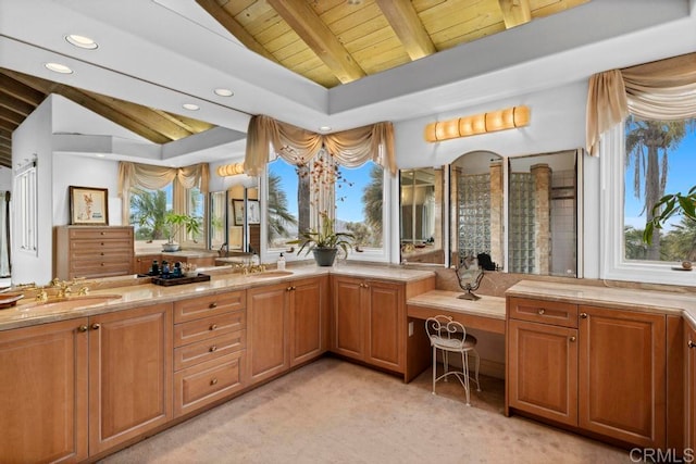 bathroom with vanity, vaulted ceiling with beams, wooden ceiling, and a healthy amount of sunlight