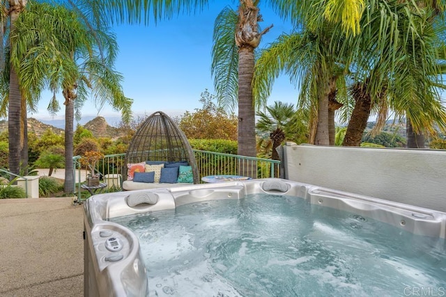 view of swimming pool with a hot tub and a mountain view