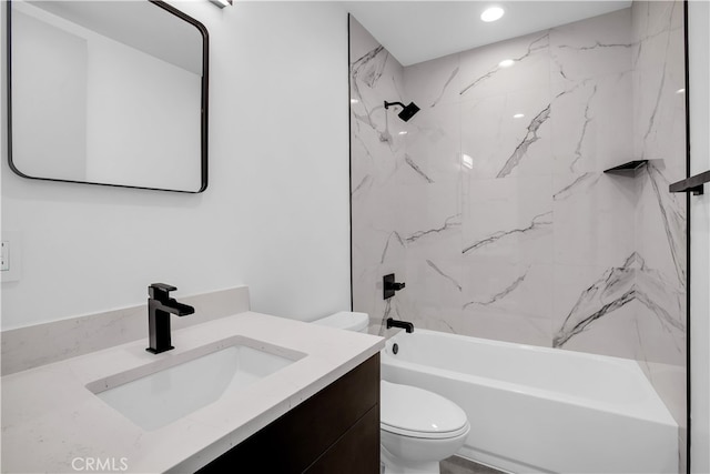 full bathroom featuring vanity, tiled shower / bath combo, and toilet