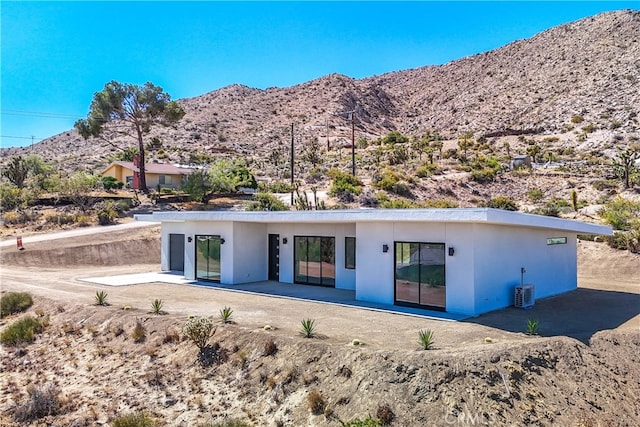 rear view of property featuring a mountain view and a patio