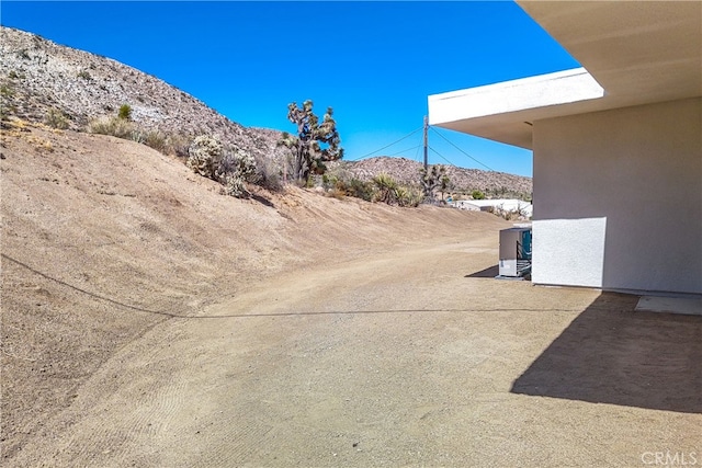 exterior space featuring a mountain view and central air condition unit