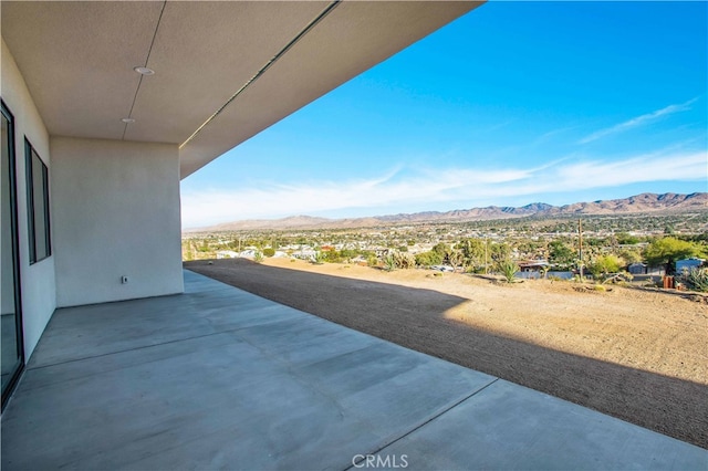 view of patio / terrace featuring a mountain view