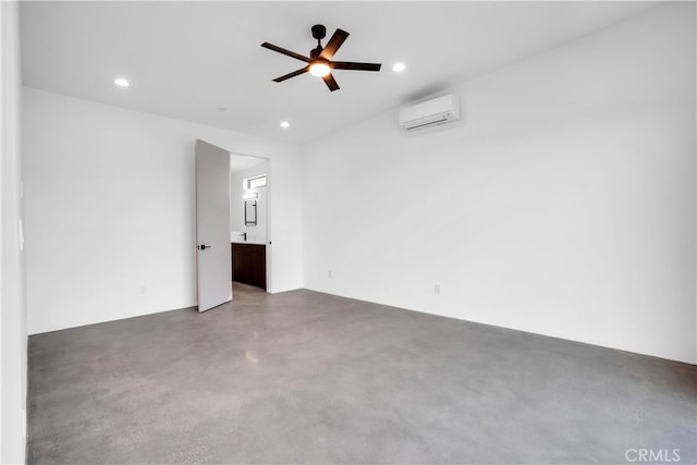 spare room with ceiling fan and a wall mounted air conditioner