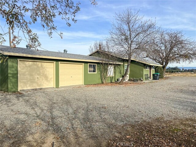 view of side of home with a garage