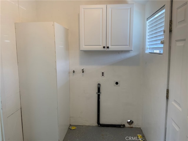 clothes washing area featuring cabinets, hookup for a gas dryer, and electric dryer hookup