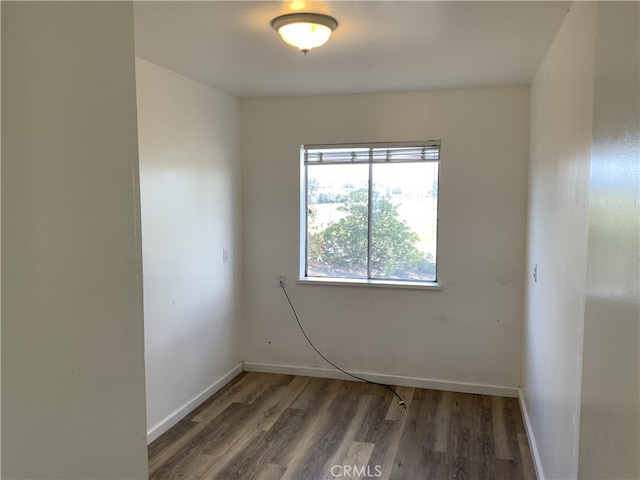 empty room featuring dark wood-type flooring