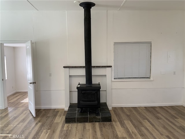 interior details with a wood stove and hardwood / wood-style floors