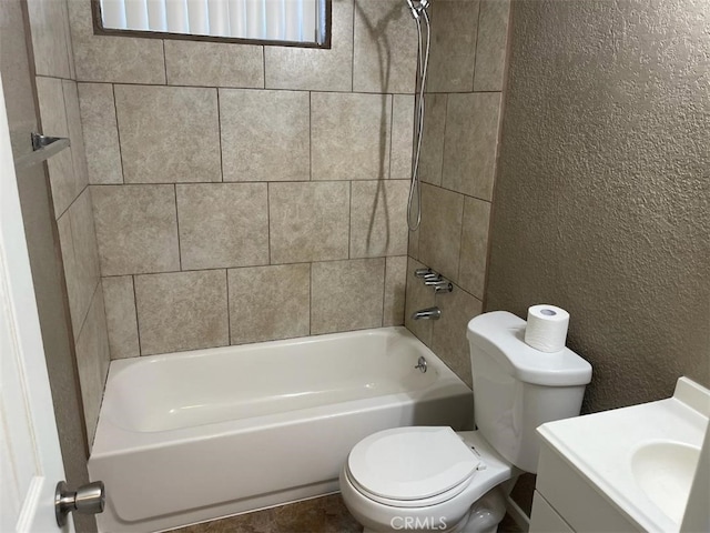 full bathroom featuring toilet, tiled shower / bath combo, and vanity