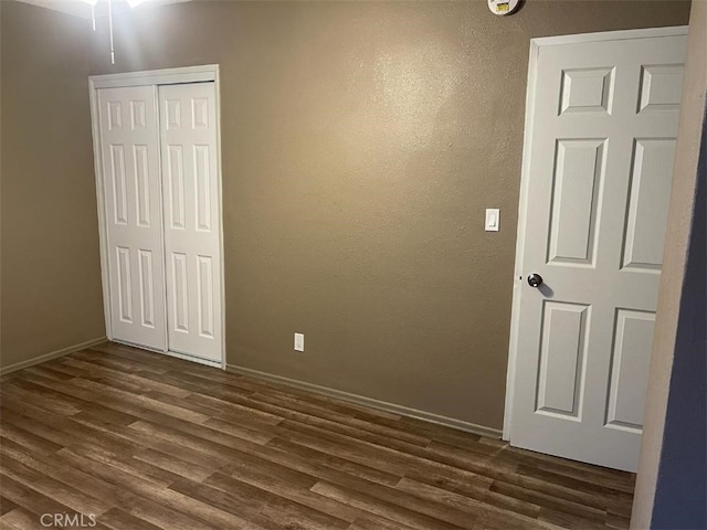 spare room featuring dark wood-type flooring