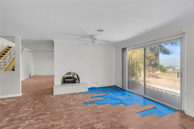 unfurnished living room featuring visible vents, ceiling fan, and stairs