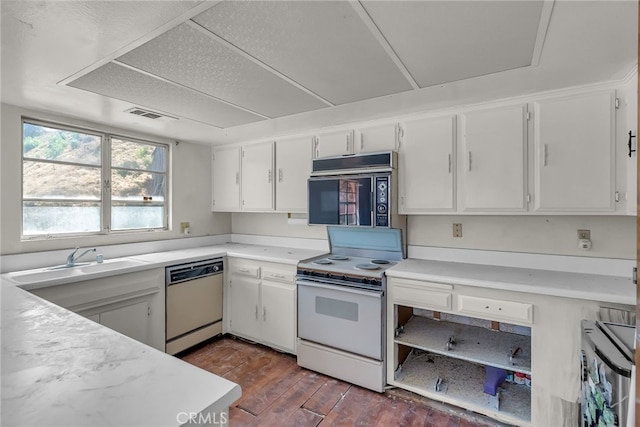 kitchen featuring a sink, dark wood-style flooring, white appliances, light countertops, and white cabinets