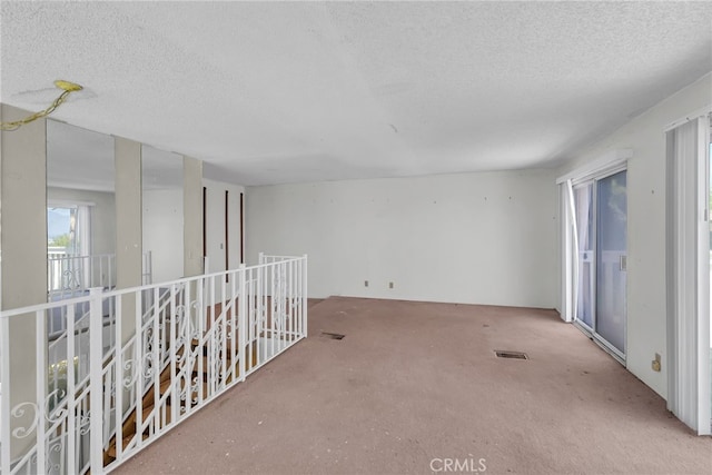 spare room with a textured ceiling and visible vents