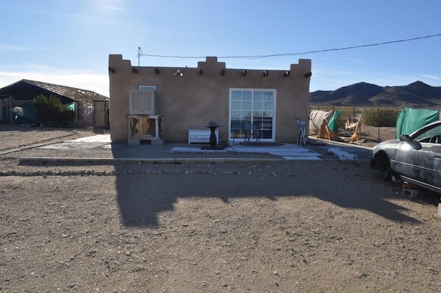 rear view of property featuring a mountain view