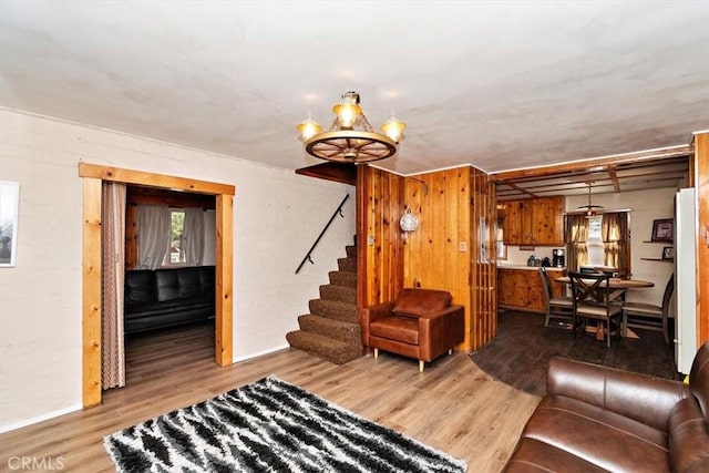 living room with a notable chandelier and wood-type flooring