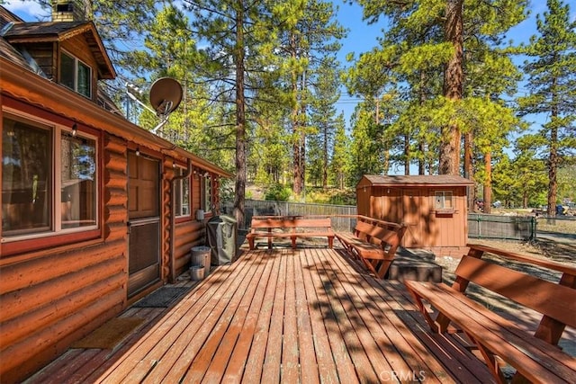 wooden deck featuring a storage unit