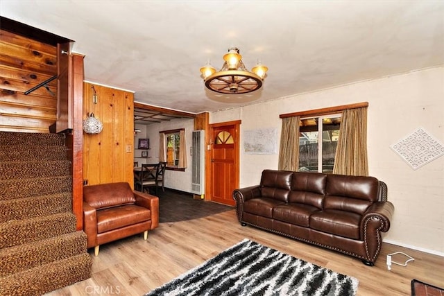 living room with hardwood / wood-style floors and a chandelier