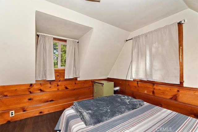 bedroom with wood-type flooring and lofted ceiling