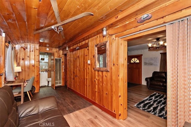 living room featuring hardwood / wood-style flooring, wood ceiling, and wooden walls