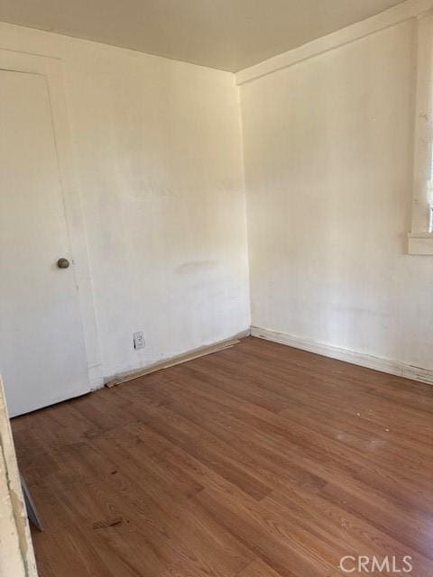 unfurnished room with dark wood-type flooring