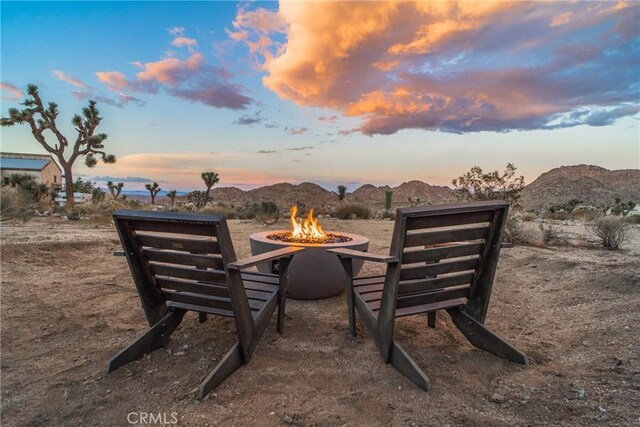 exterior space featuring a mountain view and an outdoor fire pit