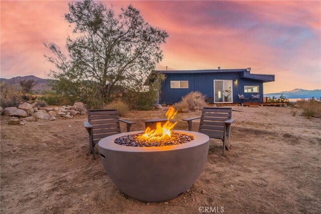 exterior space featuring a mountain view and a fire pit