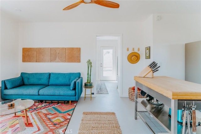 living room with concrete floors and ceiling fan