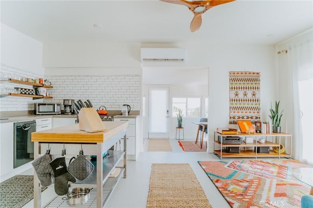 kitchen featuring a wall mounted AC, decorative backsplash, white cabinets, and black dishwasher