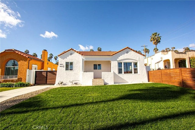 mediterranean / spanish home with a front yard