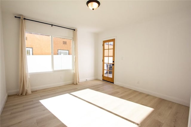 spare room featuring light hardwood / wood-style floors