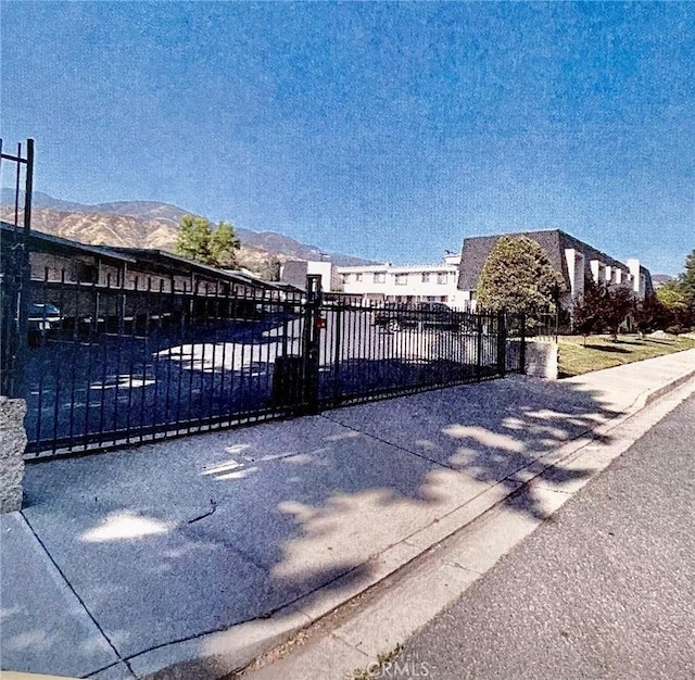 view of gate with a mountain view