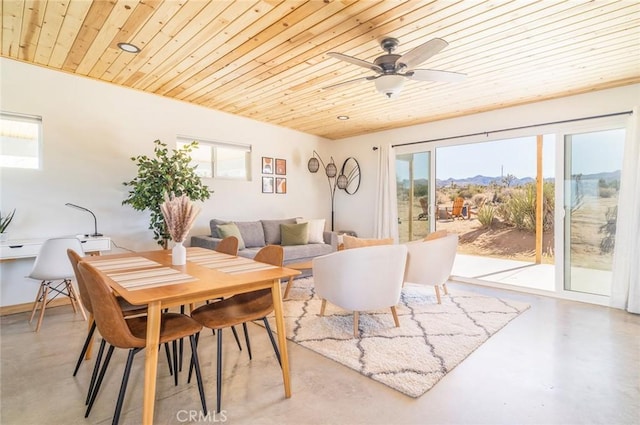 59149 Desert Gold Dr, Yucca Valley, CA 92284 - dining space with concrete floors, wood ceiling, healthy amount of natural light, and a mountain view