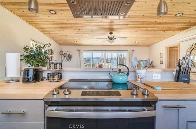 59149 Desert Gold Dr, Yucca Valley, CA 92284 - kitchen with wood ceiling, stainless steel electric stove, gray cabinets, and a wall mounted air conditioner