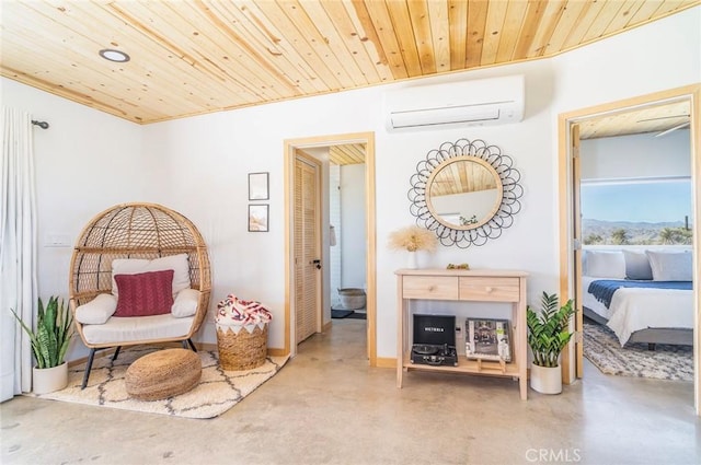 sitting room with concrete flooring, a wall mounted AC, and wooden ceiling