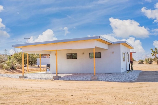 rear view of house featuring a carport